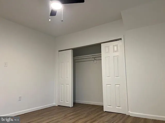 a view of an empty room and wooden floor