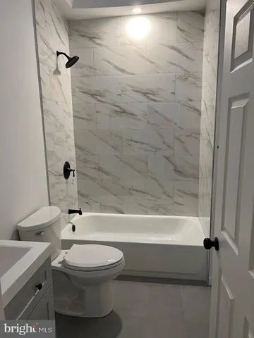 a bathroom with a toilet a sink and bathtub