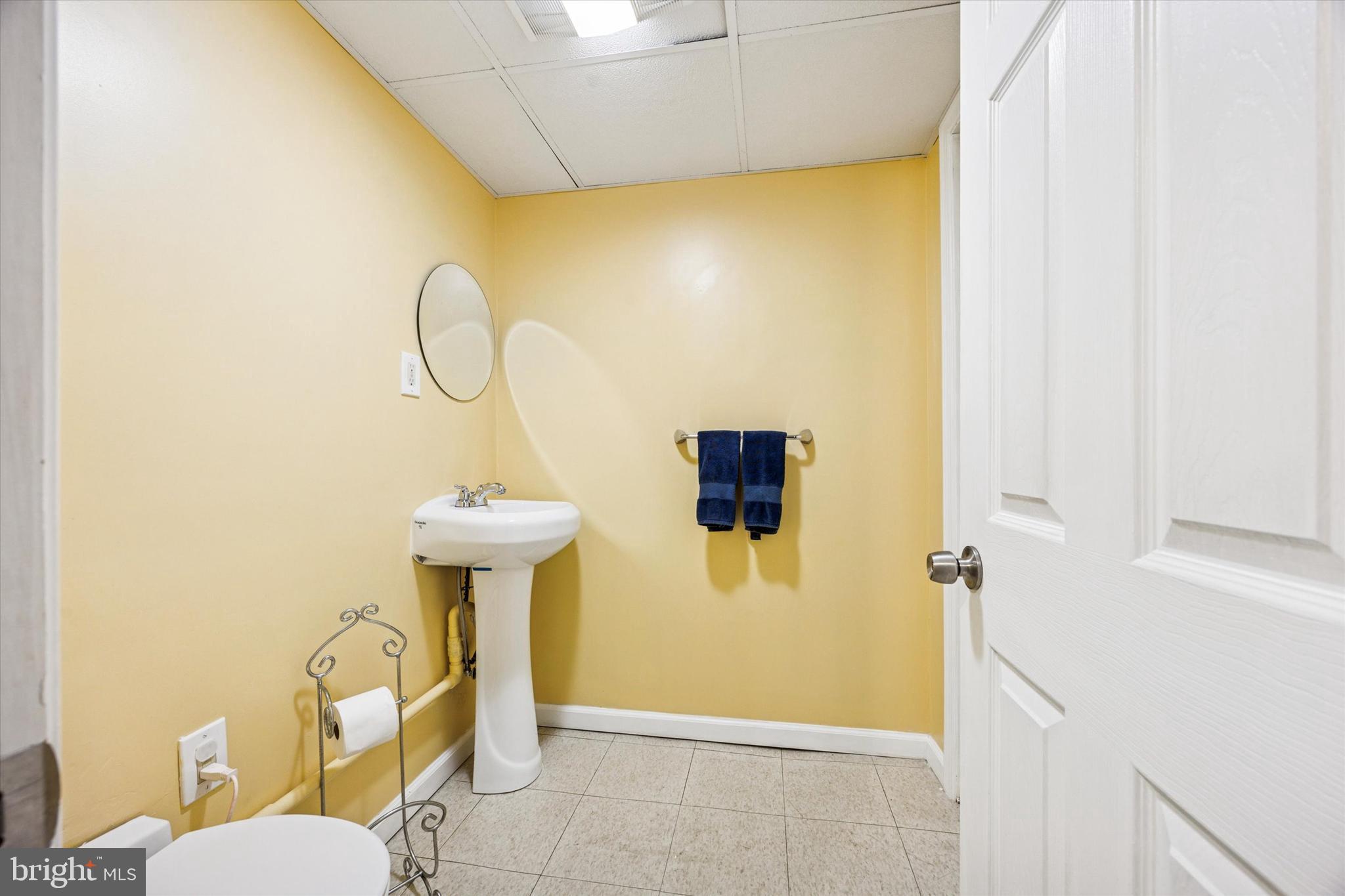 22 Mansfield Road Lansdowne, PA 19050 - Photo 21 of 25 a bathroom with a sink a toilet and a mirror