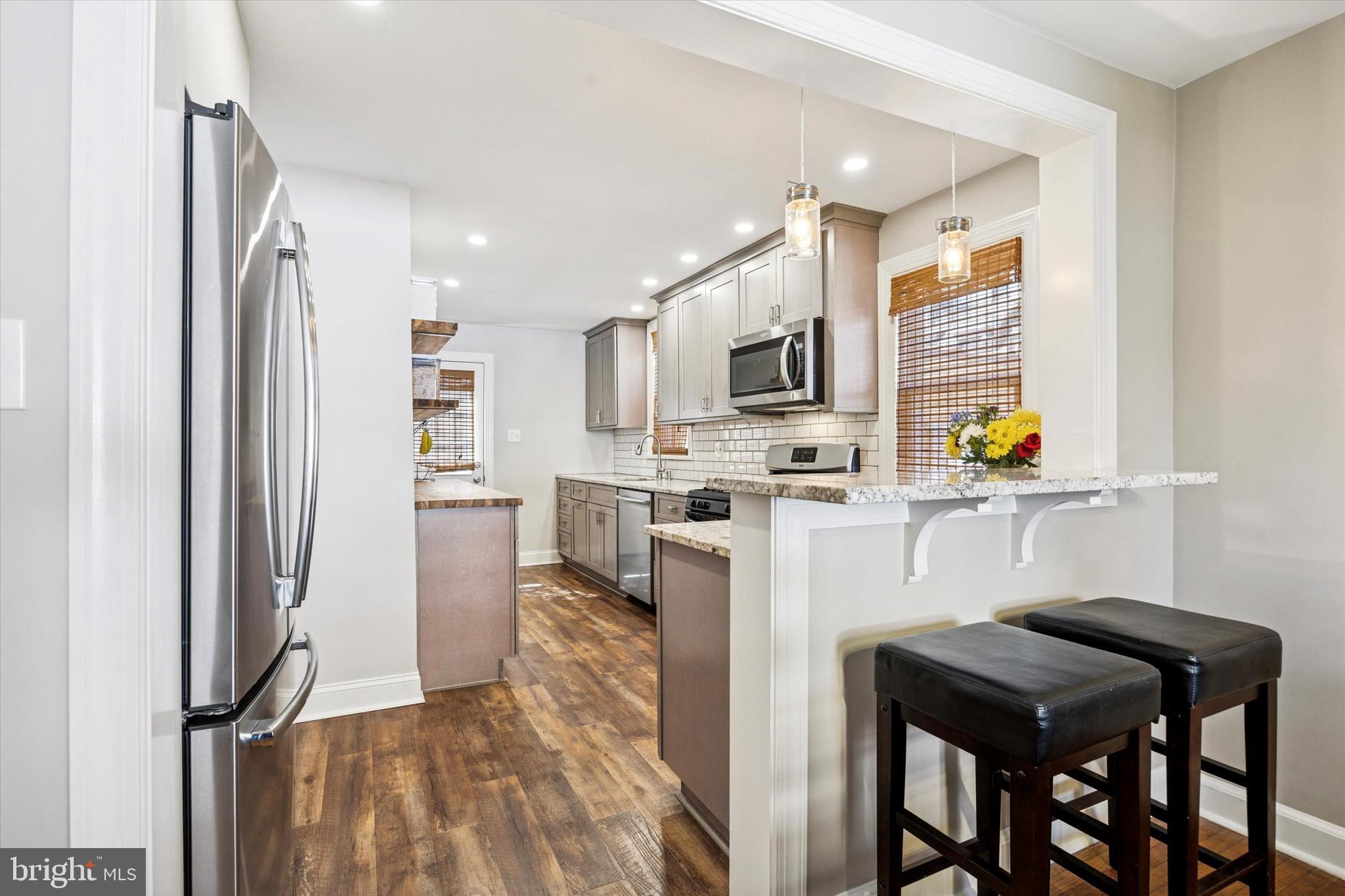22 Mansfield Road Lansdowne, PA 19050 - Photo 7 of 25 a kitchen with stainless steel appliances a refrigerator and a stove top oven