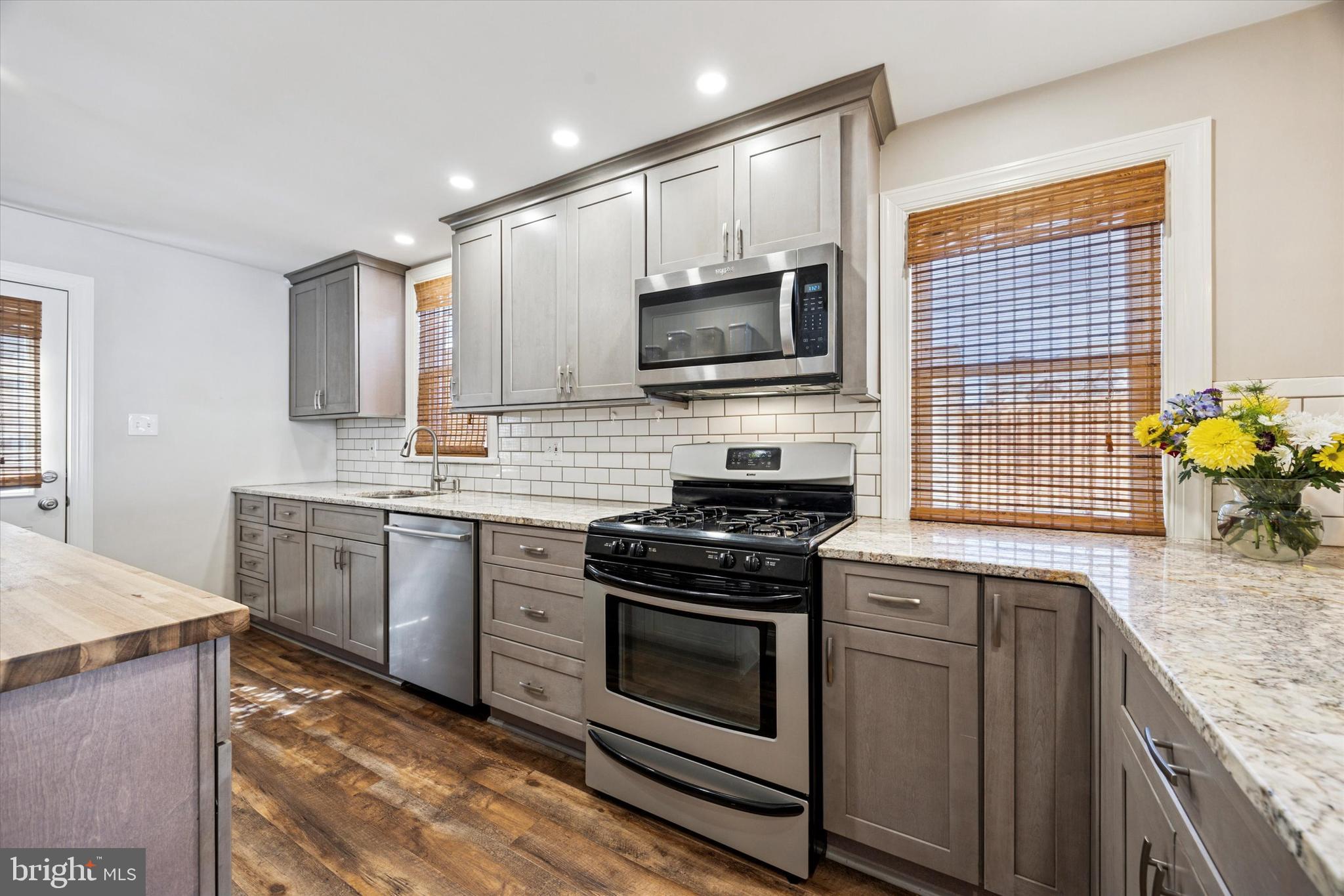 22 Mansfield Road Lansdowne, PA 19050 - Photo 8 of 25 a kitchen with granite countertop a stove sink and microwave