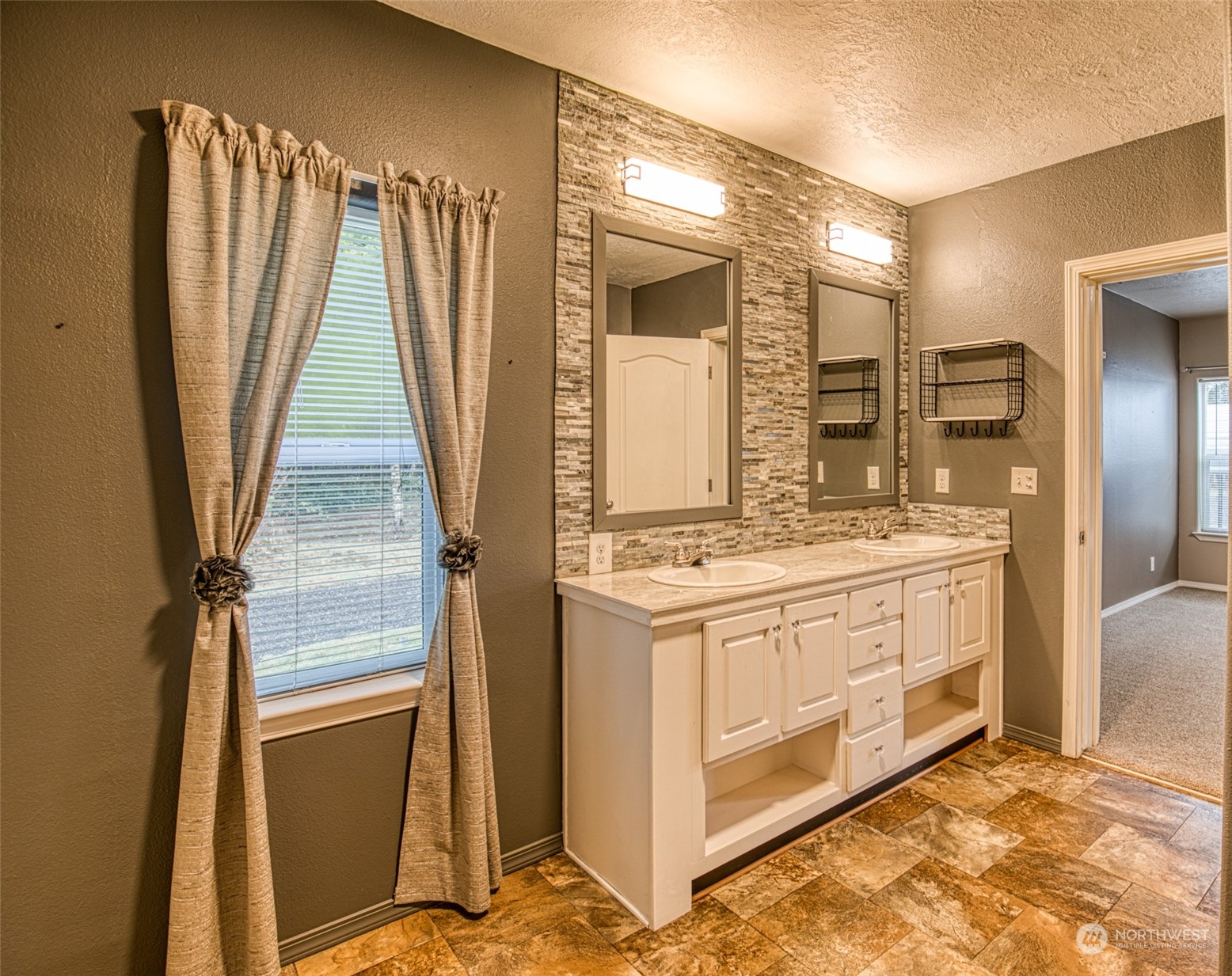 123 South Union Road Elma, WA 98541 - Photo 13 of 30 a bathroom with a double vanity sink and a mirror