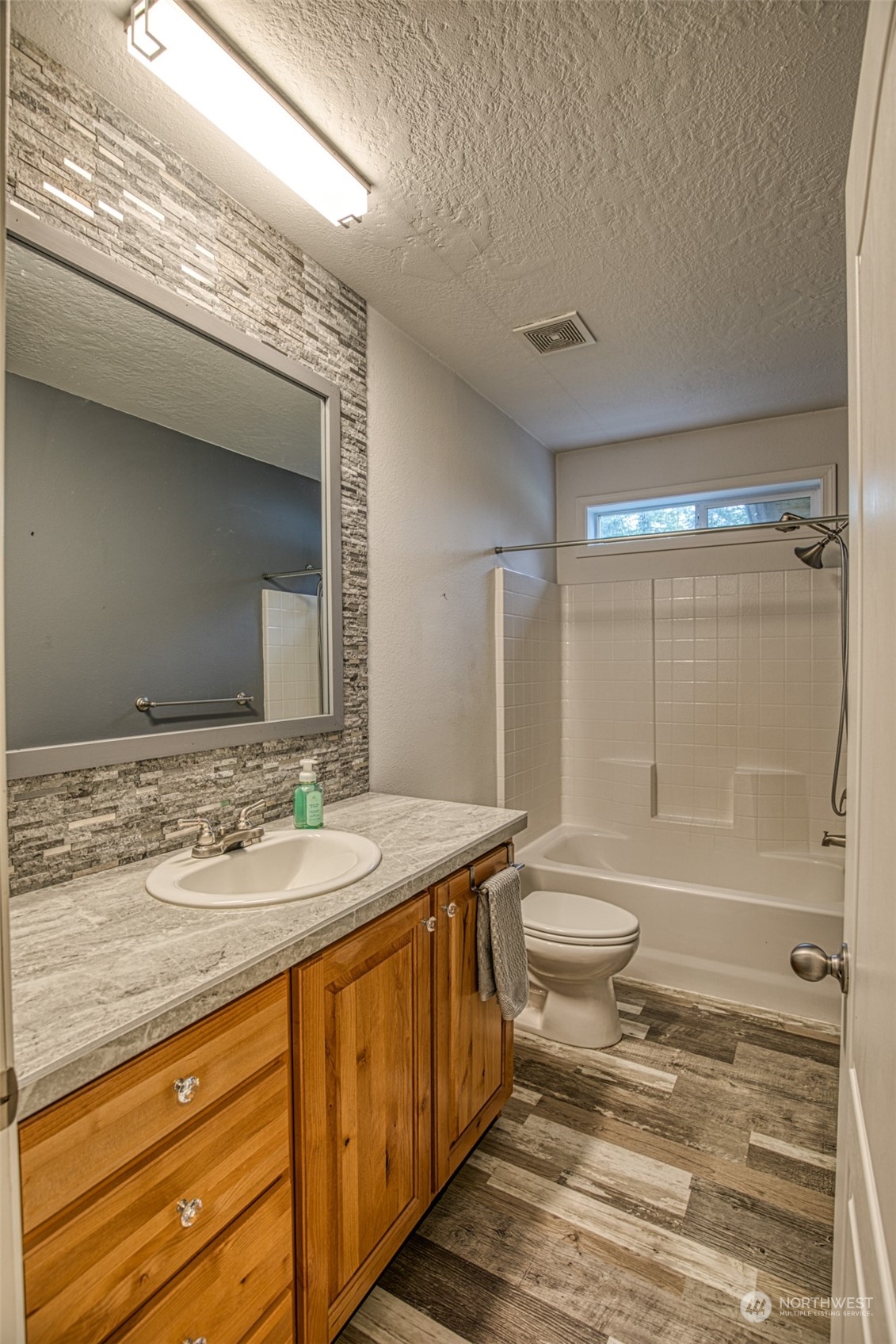 123 South Union Road Elma, WA 98541 - Photo 17 of 30 a bathroom with a granite countertop sink mirror vanity and toilet