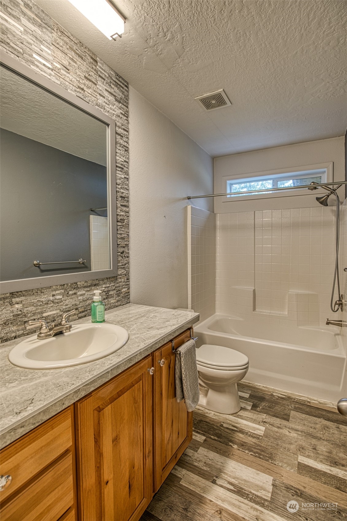 123 South Union Road Elma, WA 98541 - Photo 18 of 30 a bathroom with a granite countertop sink toilet mirror and bathtub