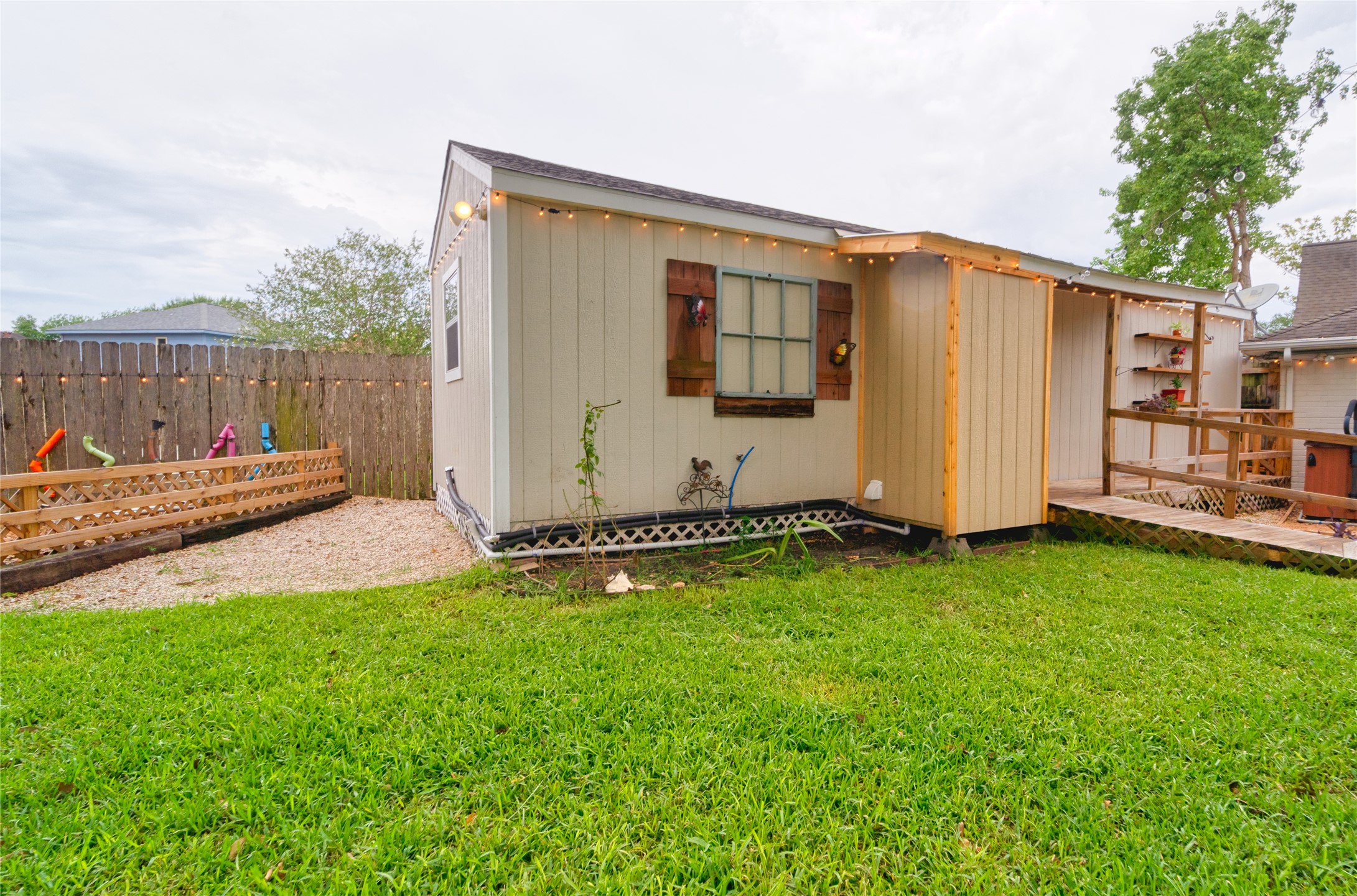 6951 Leandra Drive Houston, TX 77083 - Photo 12 of 12 a view of a backyard with potted plants and wooden fence