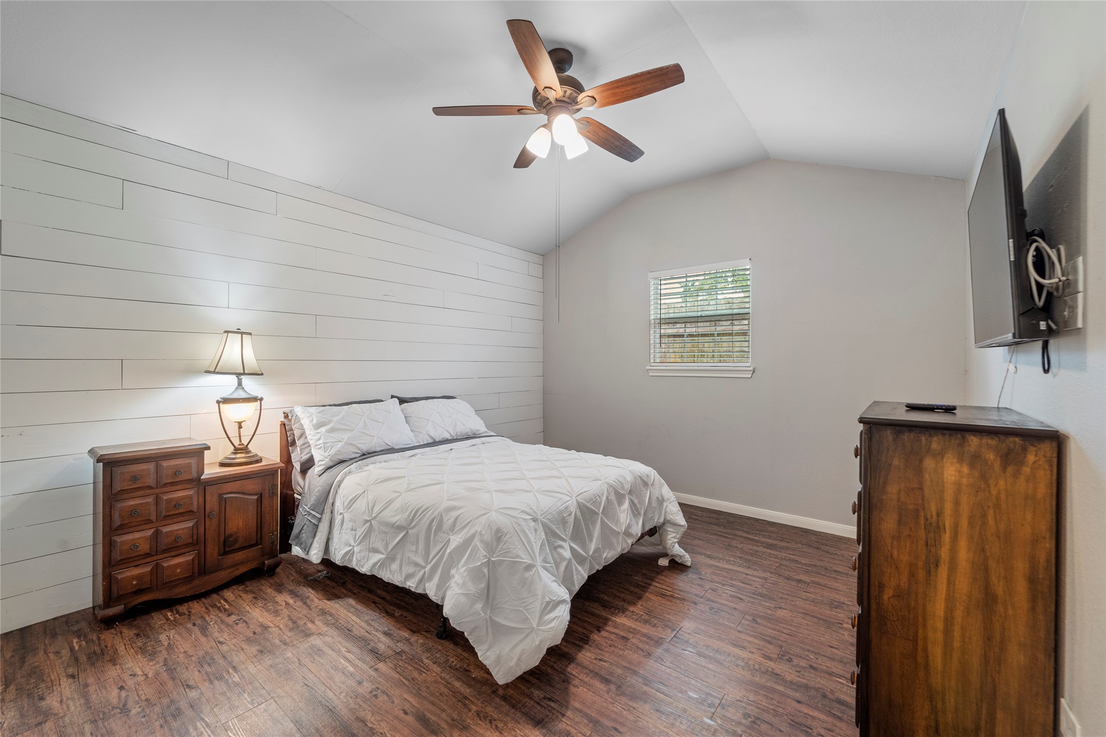 6951 Leandra Drive Houston, TX 77083 - Photo 6 of 12 a bedroom with a bed dresser and a flat tv screen