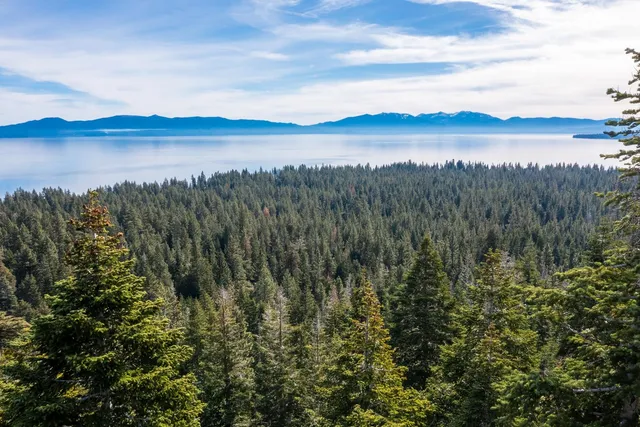 a view of a lake and green valley