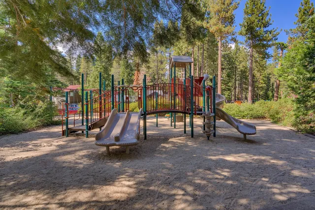 a view of outdoor space with playground and green space