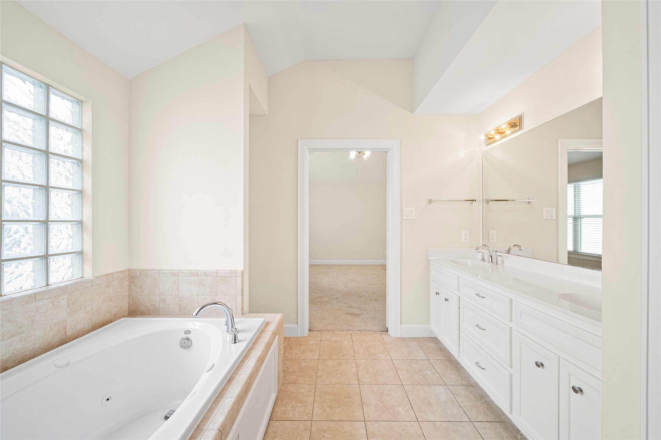 3726 Main Poplar Drive Houston, TX 77025 - Photo 16 of 25 a bathroom with a tub a sink and a large mirror