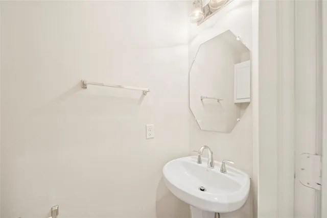 a bathroom with a sink a mirror and a shower