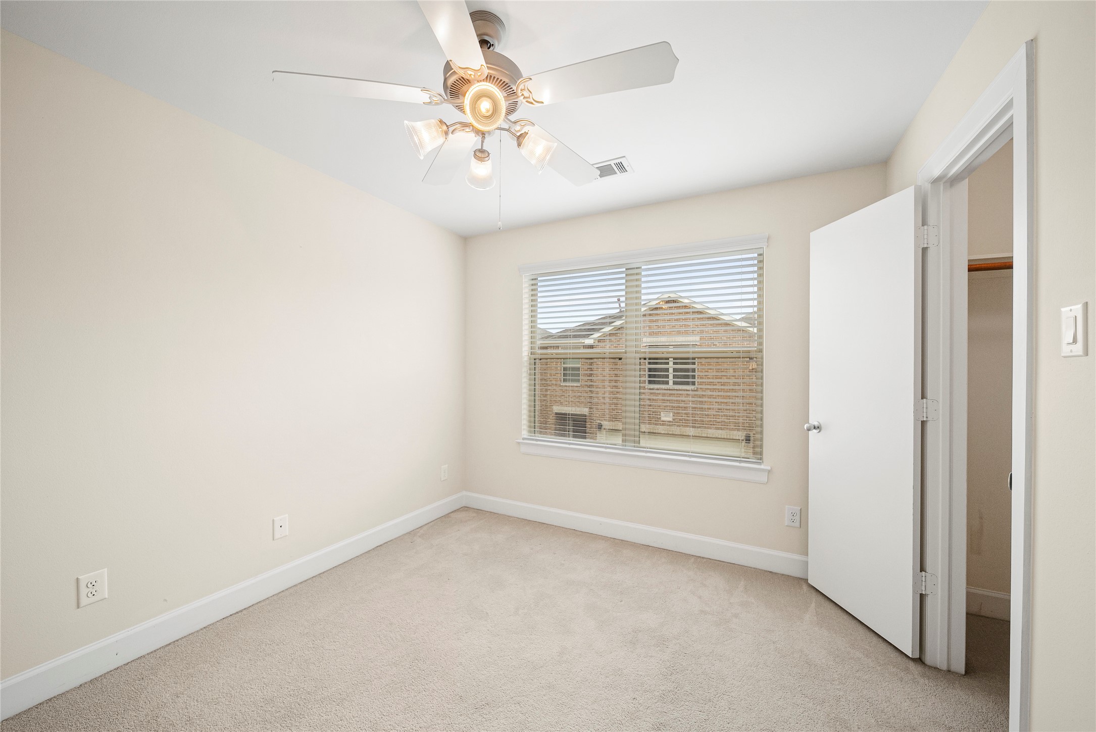 3726 Main Poplar Drive Houston, TX 77025 - Photo 22 of 25 an empty room with a chandelier fan and windows