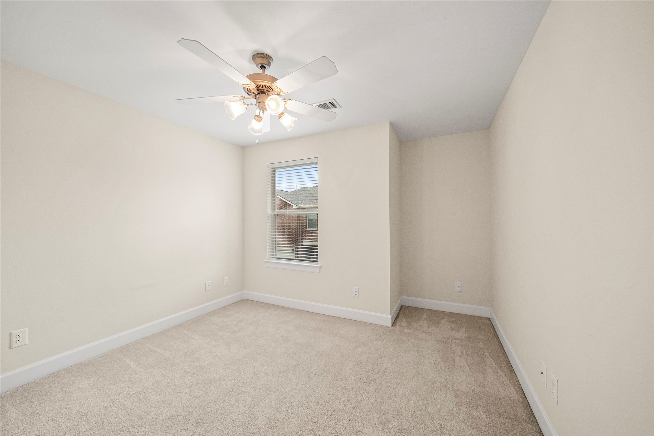 3726 Main Poplar Drive Houston, TX 77025 - Photo 23 of 25 an empty room with a window and a fan