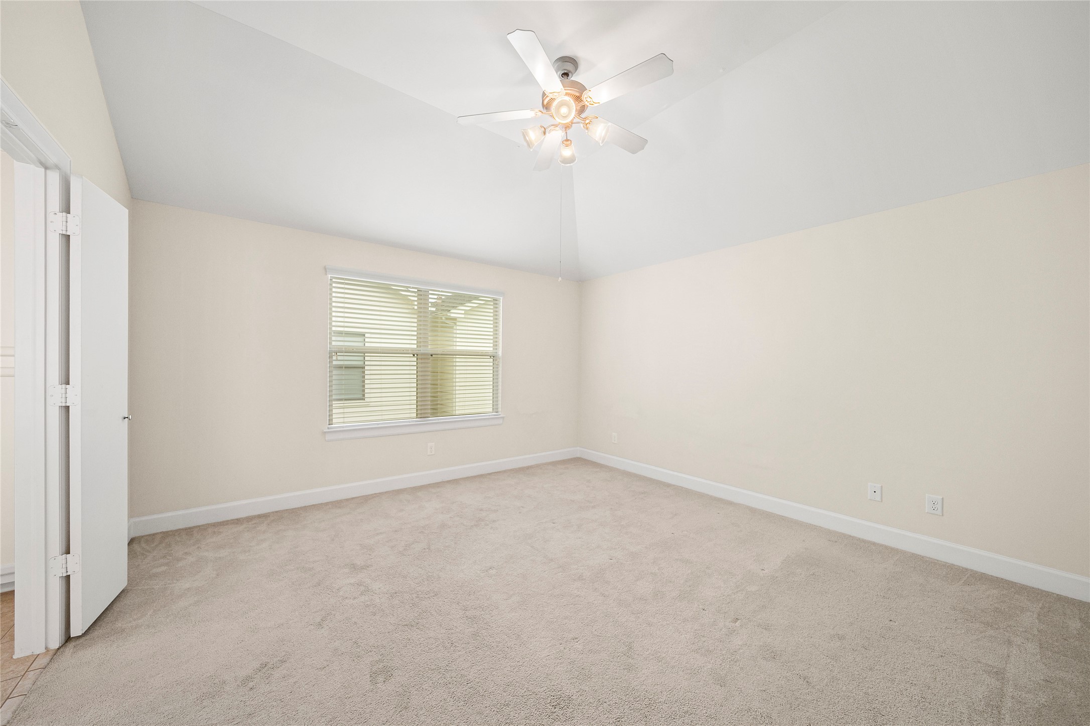 3726 Main Poplar Drive Houston, TX 77025 - Photo 24 of 25 an empty room with a chandelier fan and windows
