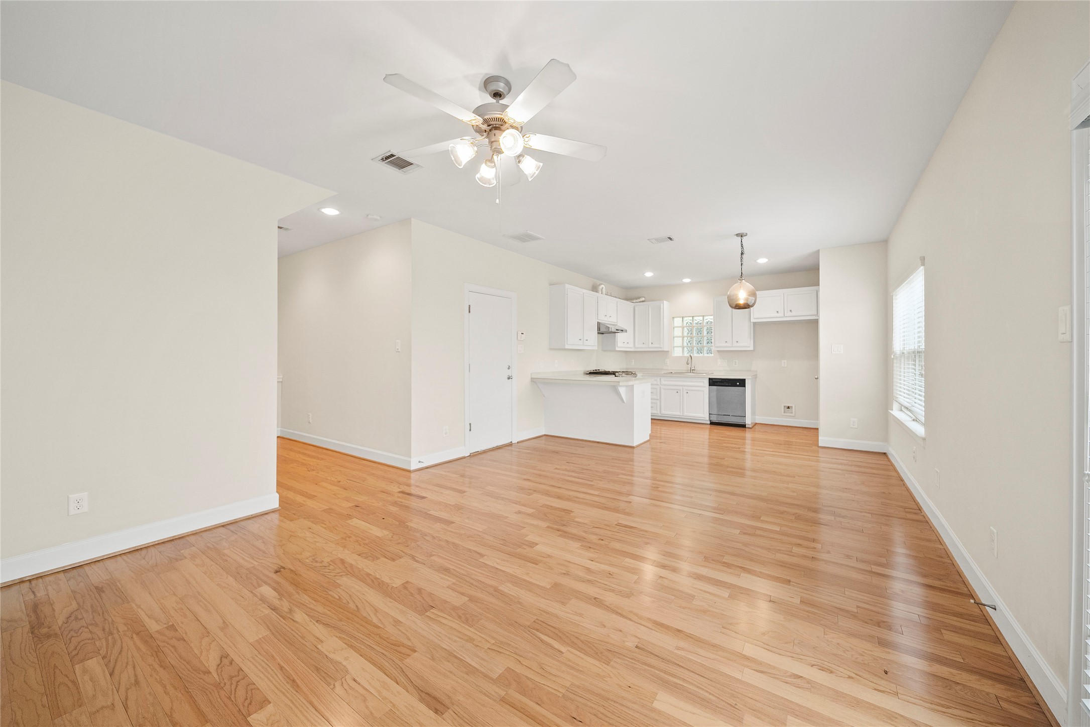 3726 Main Poplar Drive Houston, TX 77025 - Photo 3 of 25 a view of an empty room and kitchen view with wooden floor