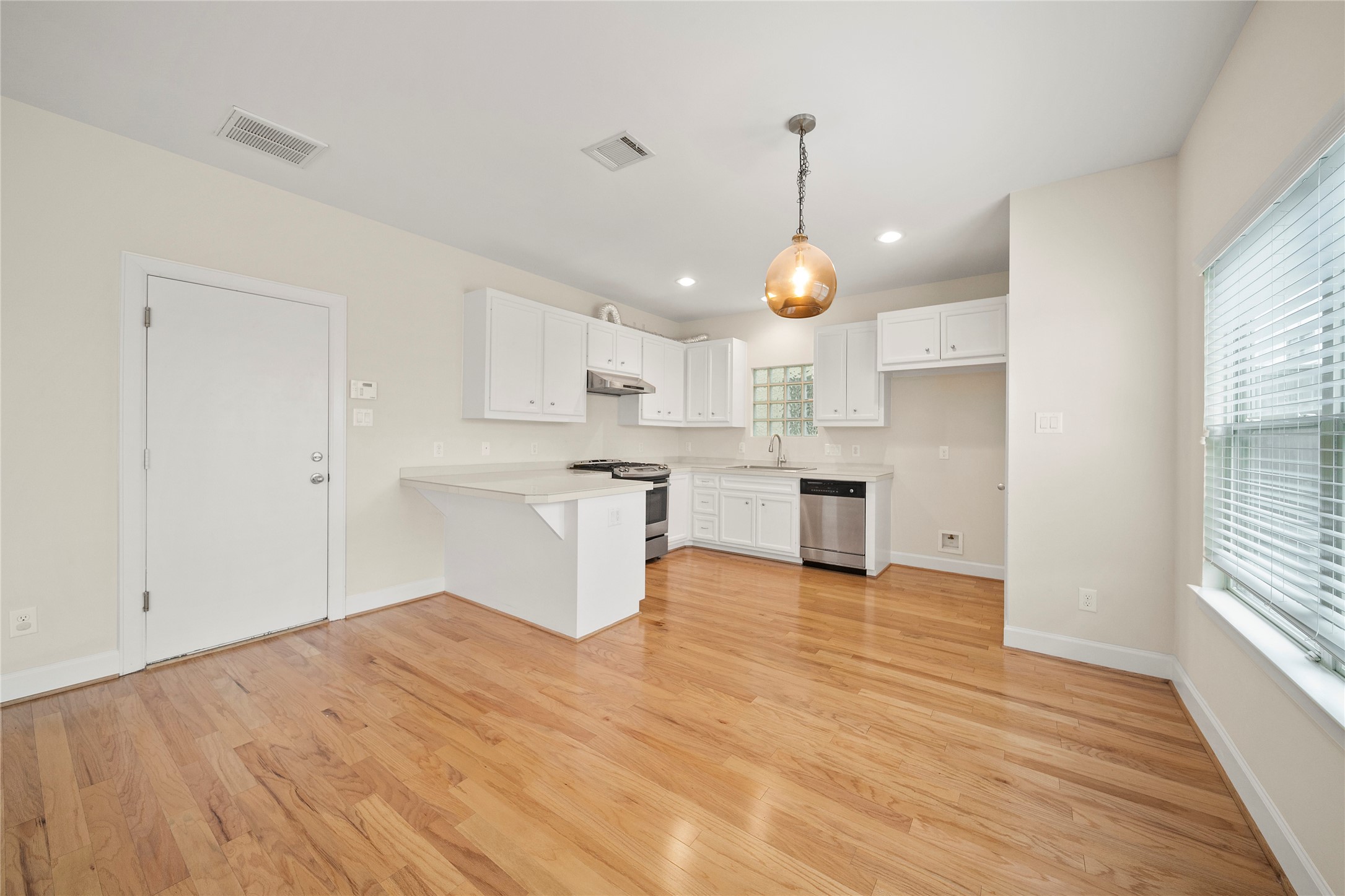 3726 Main Poplar Drive Houston, TX 77025 - Photo 5 of 25 a view of a kitchen with a sink and dishwasher a refrigerator with wooden floor
