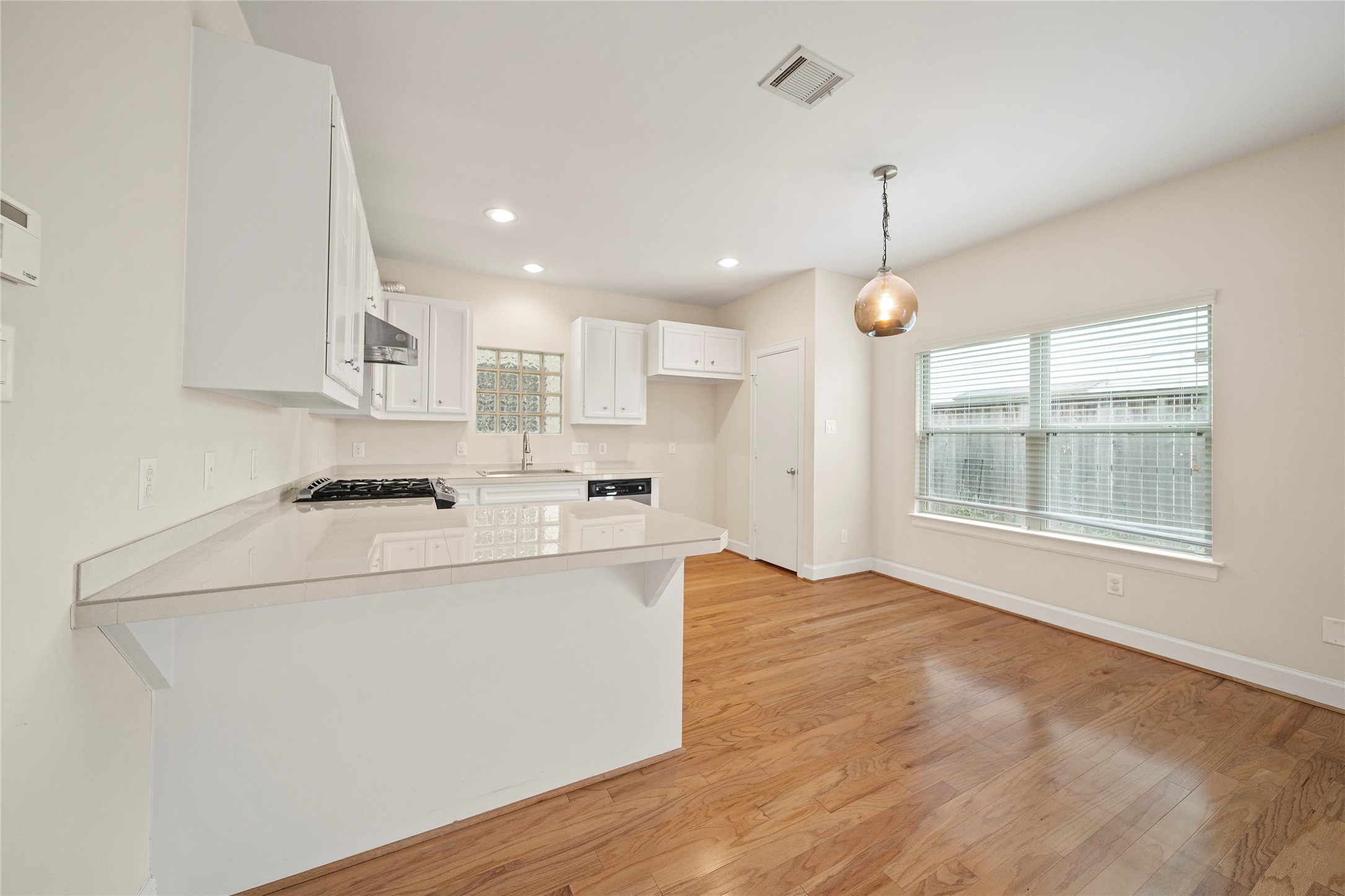 3726 Main Poplar Drive Houston, TX 77025 - Photo 6 of 25 a kitchen with kitchen island a sink a stove a refrigerator and a window