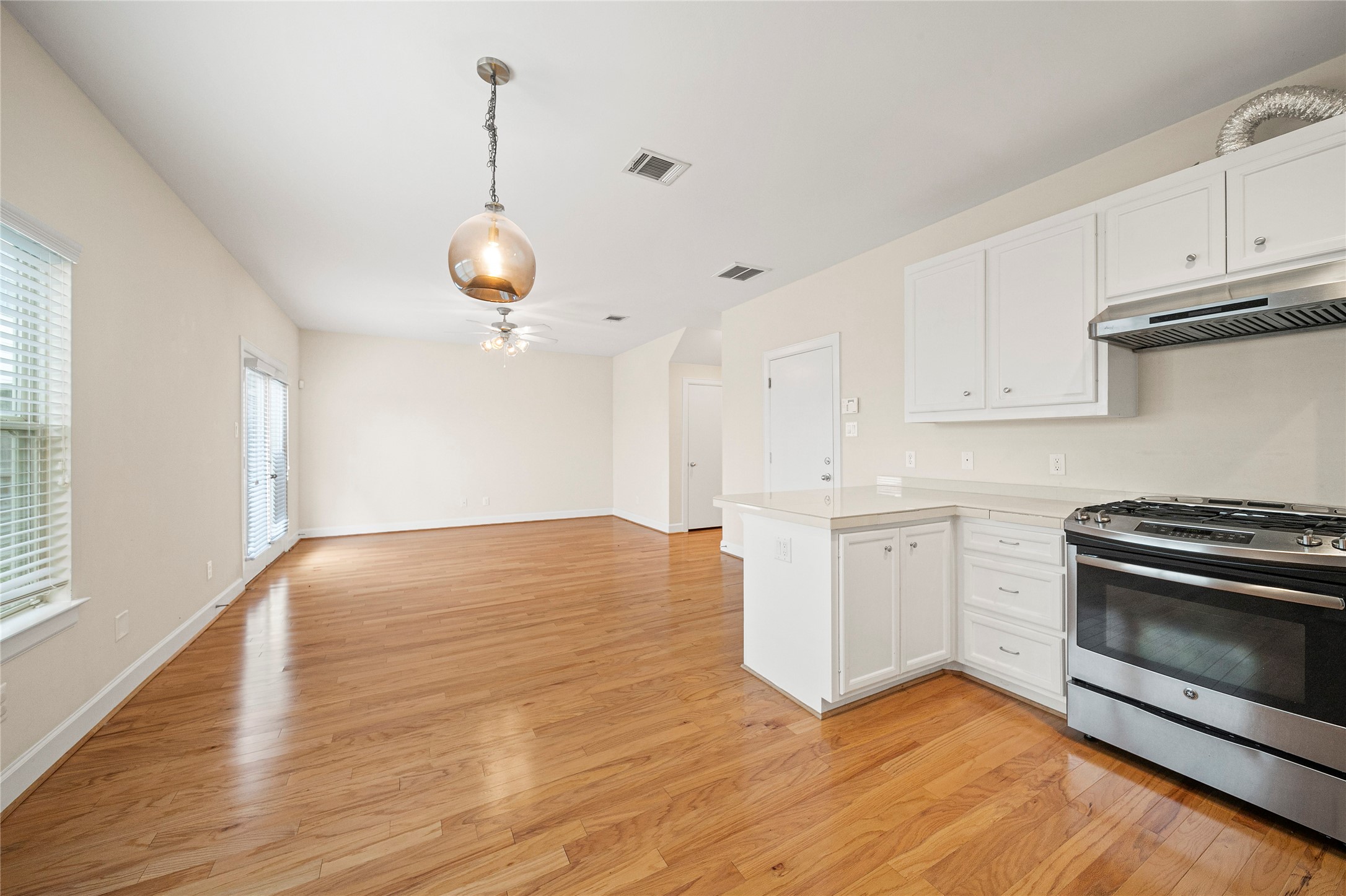 3726 Main Poplar Drive Houston, TX 77025 - Photo 7 of 25 a kitchen with wooden floors and stainless steel appliances