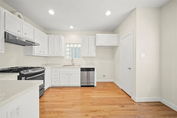 a kitchen with stainless steel appliances granite countertop a stove and a refrigerator