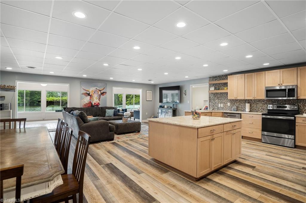 920 Panther Point Road Richfield, NC 28137 - Photo 8 of 37 Large kitchen island and luxury vinyl flooring