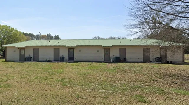 front view of a house with a yard and a garage
