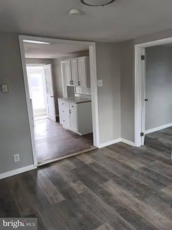 a view of a kitchen with wooden floor and a sink