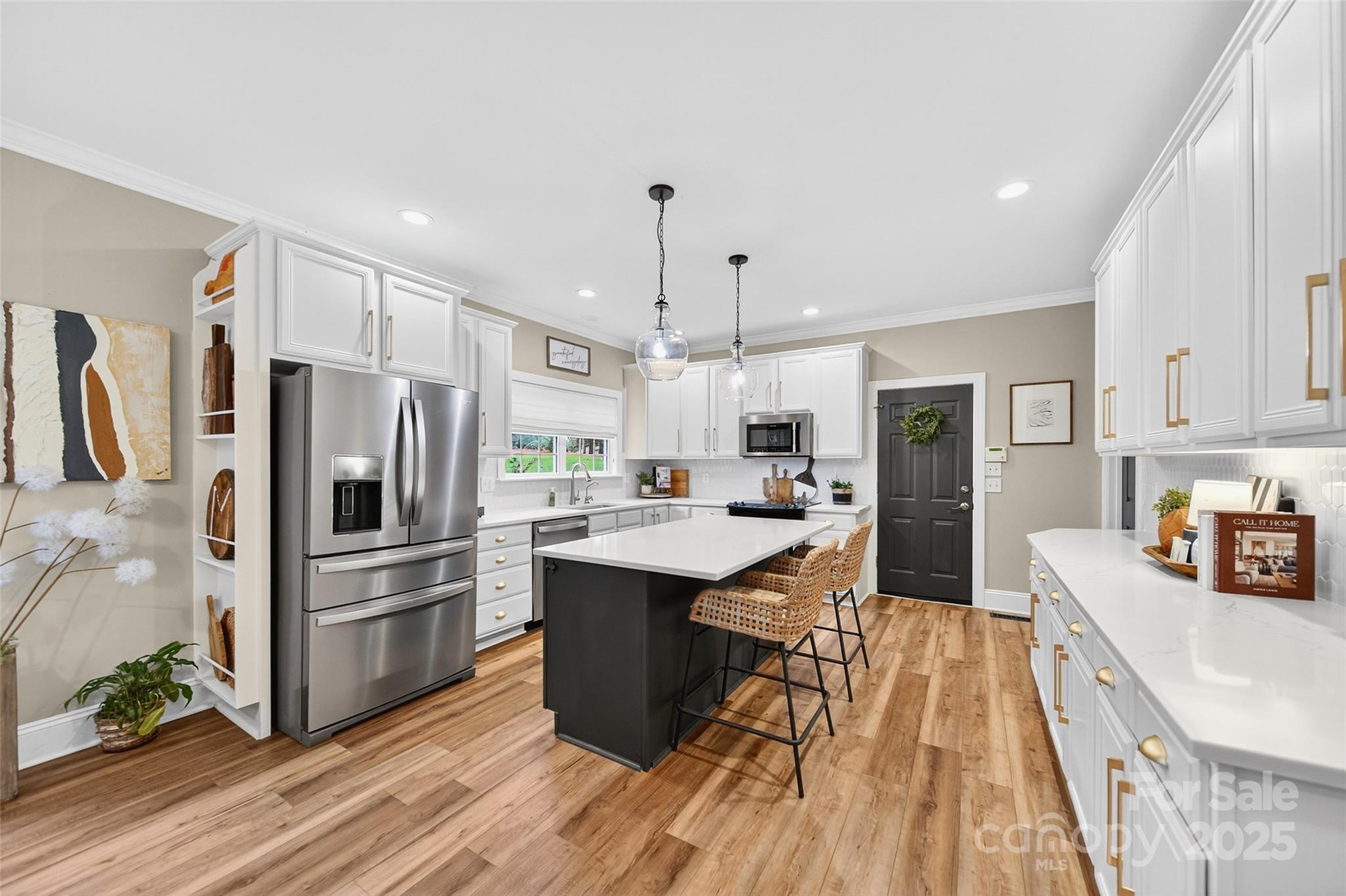 3575 Gordon Street Terrell, NC 28682 - Photo 24 of 48 a kitchen with stainless steel appliances a sink a stove a refrigerator cabinets and wooden floor
