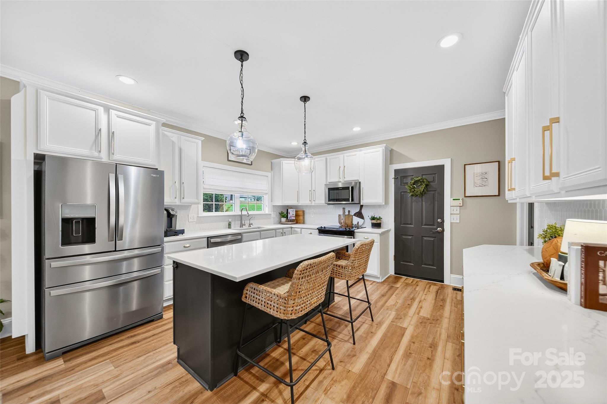 3575 Gordon Street Terrell, NC 28682 - Photo 25 of 48 a kitchen with stainless steel appliances kitchen island granite countertop a refrigerator a stove a sink dishwasher and a refrigerator with wooden floor
