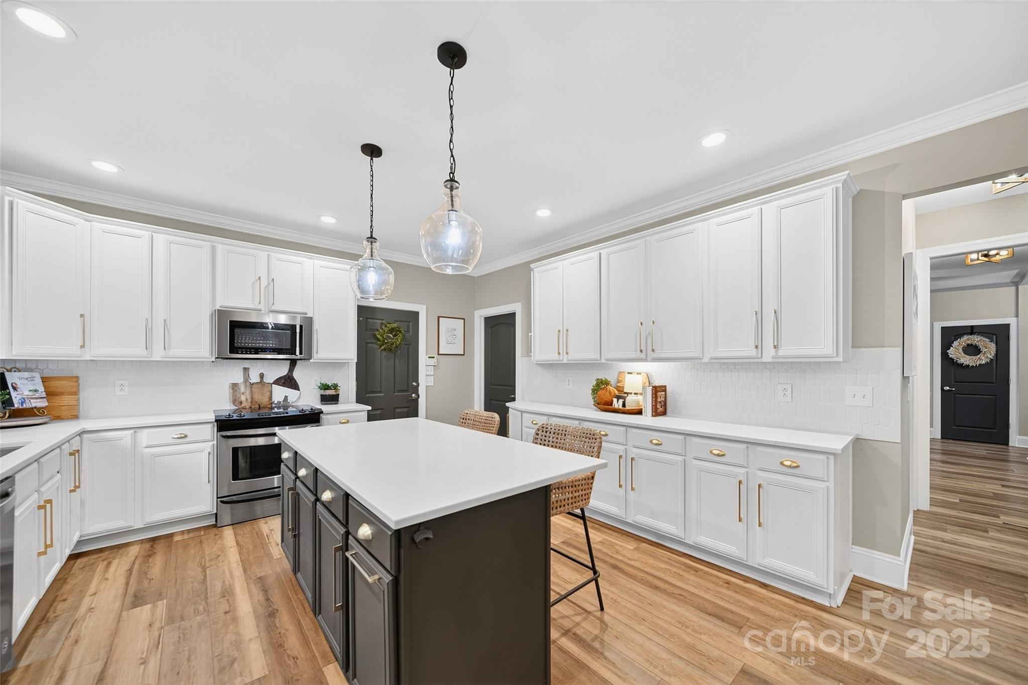 3575 Gordon Street Terrell, NC 28682 - Photo 29 of 48 a kitchen with stainless steel appliances kitchen island a stove a sink and a refrigerator