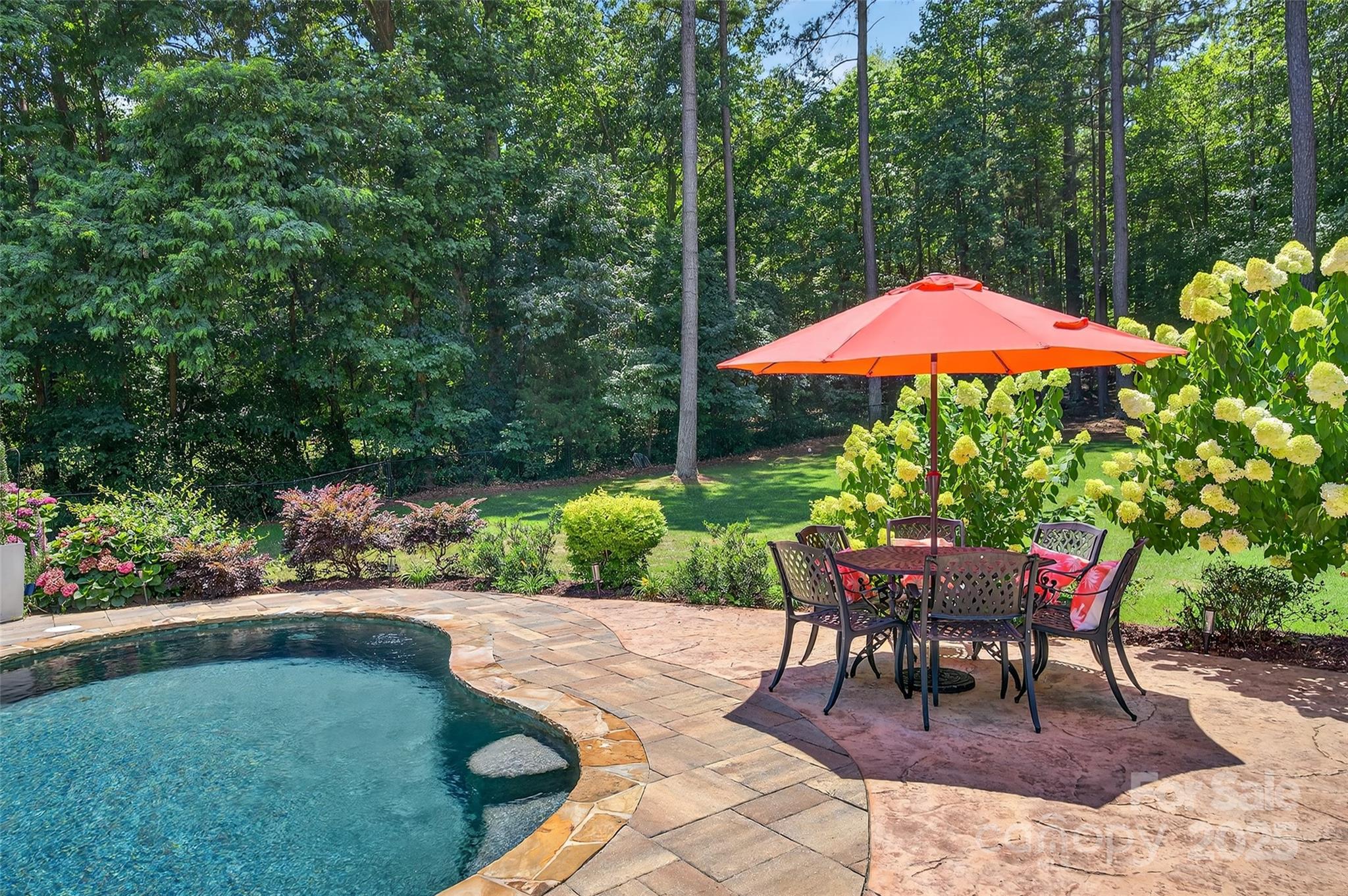 3575 Gordon Street Terrell, NC 28682 - Photo 7 of 48 a patio with a table and chairs under an umbrella