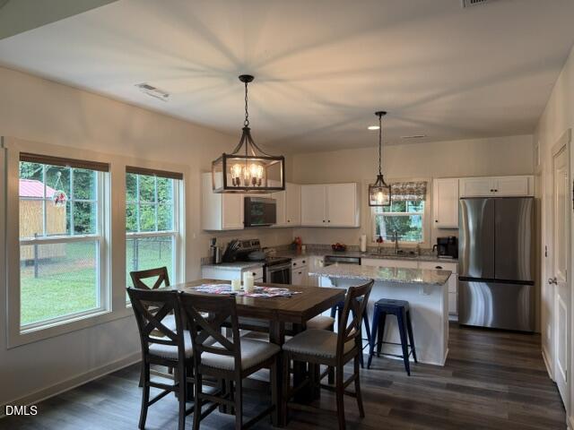 574 East Ridge Avenue Liberty, NC 27298 - Photo 8 of 28 a view of a dining room with furniture window and wooden floor