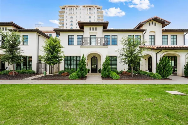 a front view of a house with a garden and plants