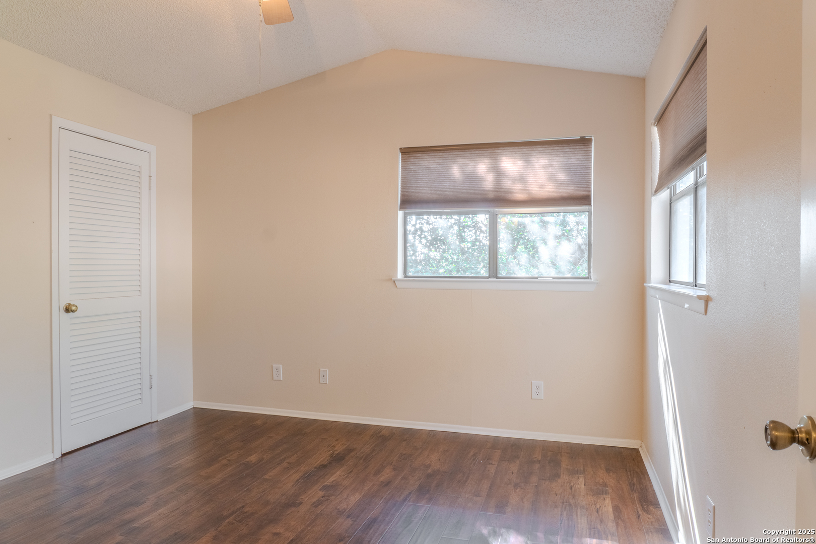 829 West Bitters Road, Unit 503 San Antonio, TX 78216 - Photo 12 of 22 an empty room with wooden floor and windows