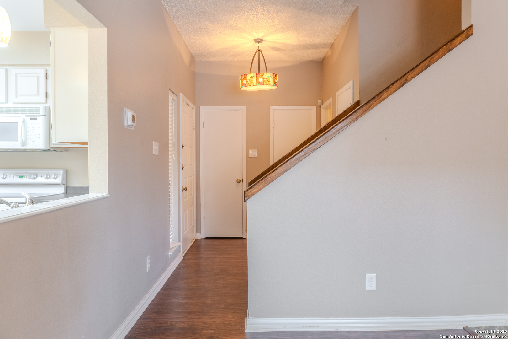 829 West Bitters Road, Unit 503 San Antonio, TX 78216 - Photo 9 of 22 a view of a hallway with wooden floor and staircase