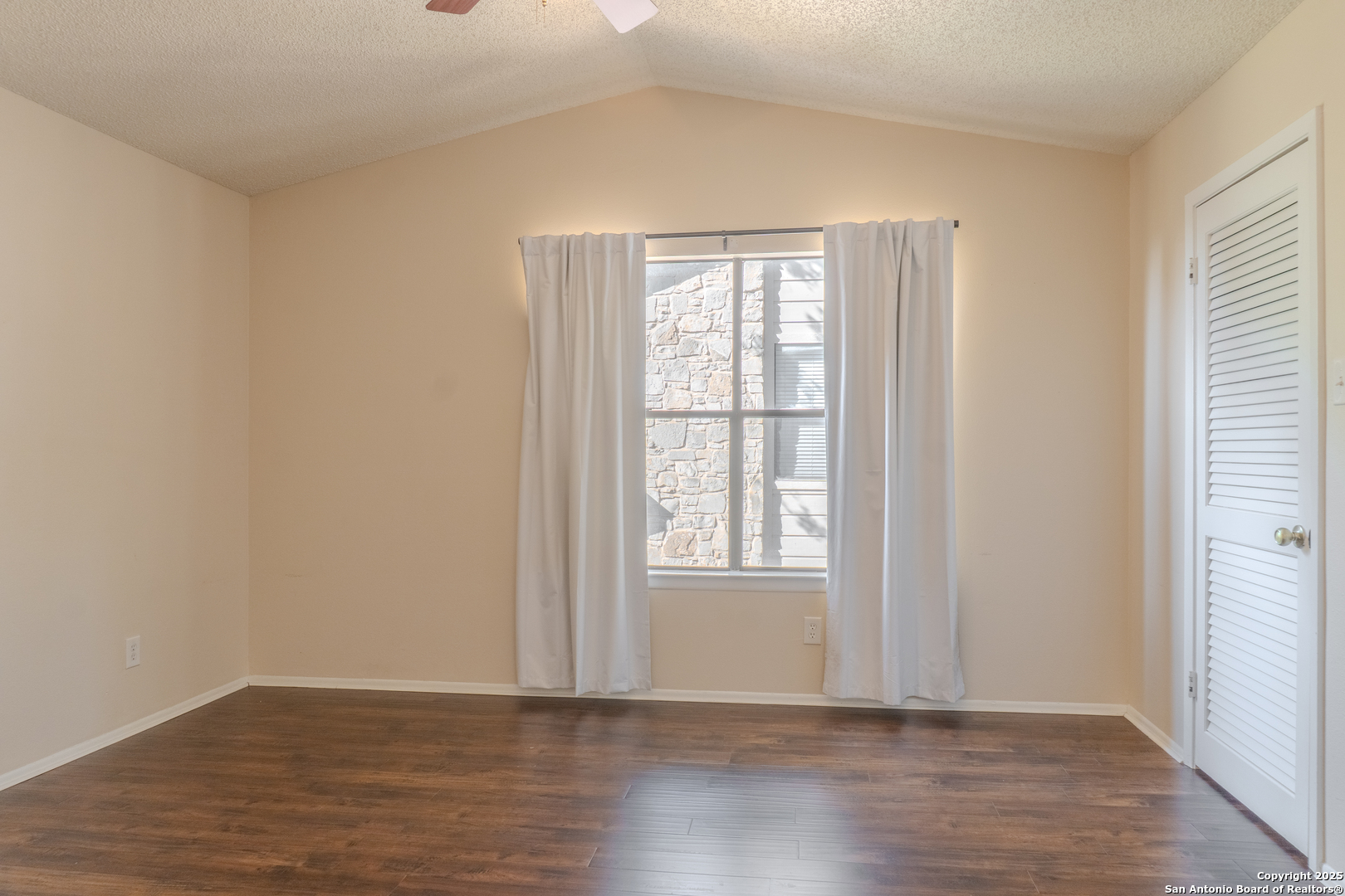 829 West Bitters Road, Unit 503 San Antonio, TX 78216 - Photo 10 of 22 an empty room with wooden floor and windows