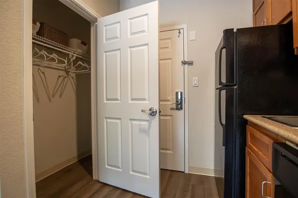 a view of walk in closet with wooden floor