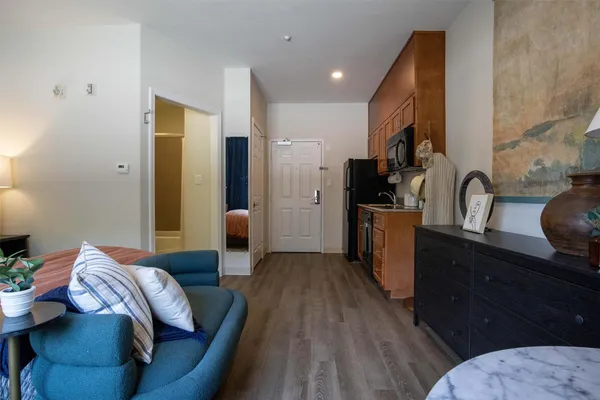 a bedroom with furniture and a flat screen tv