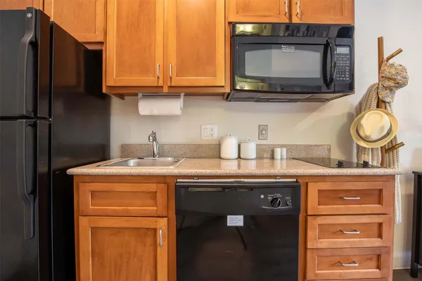 a kitchen with stainless steel appliances granite countertop a sink and a microwave