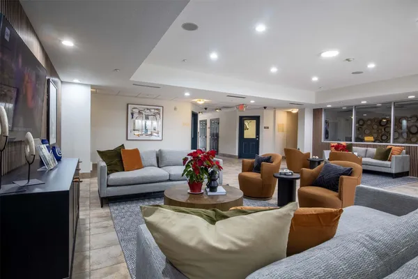 a living room with furniture and a chandelier