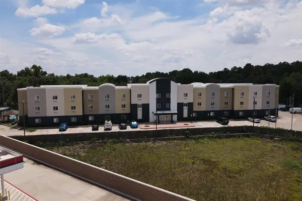 an aerial view of residential houses with outdoor space and swimming pool