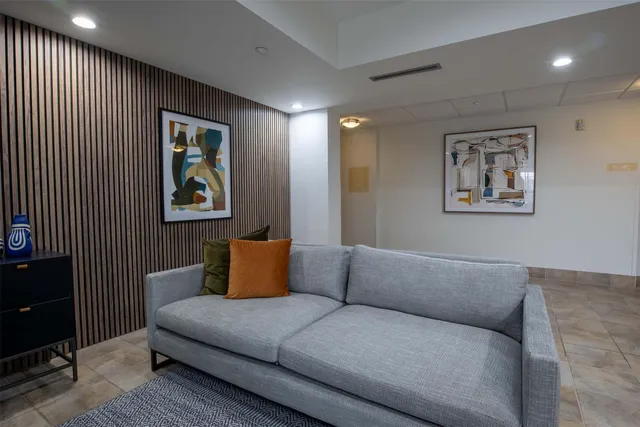 a living room with furniture and painting on the wall