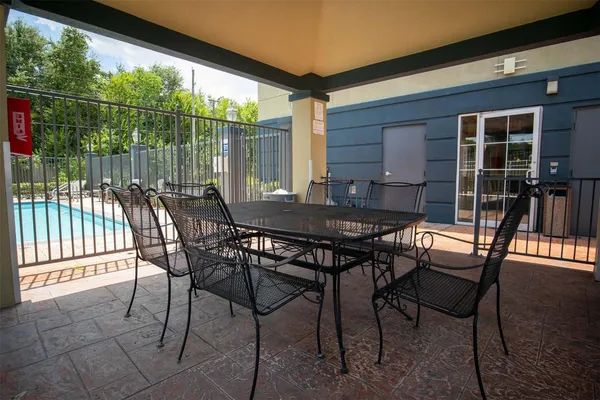 a view of a backyard with a patio and outdoor seating