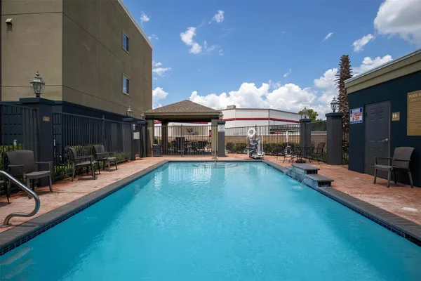 a view of a swimming pool with sitting area