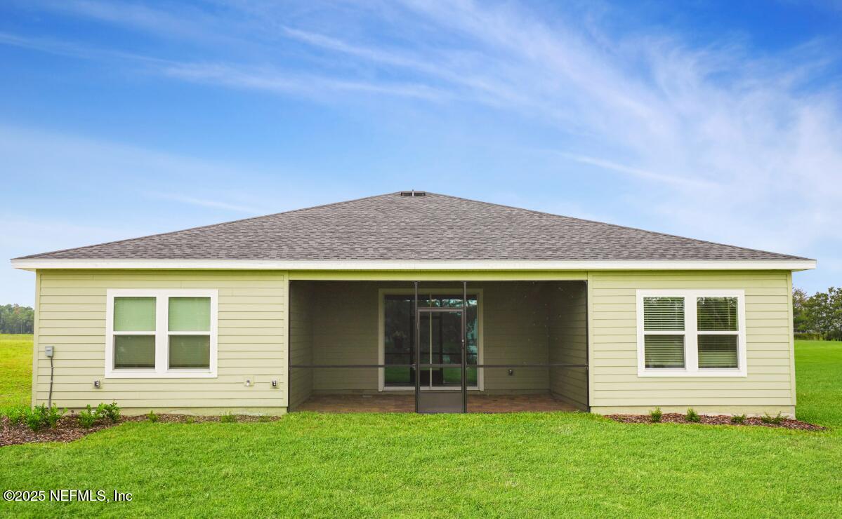 75705 Walking Path Lane Yulee, FL 32097 - Photo 23 of 37 a view of front of a house with a yard