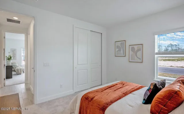 a bedroom with a bed and a window