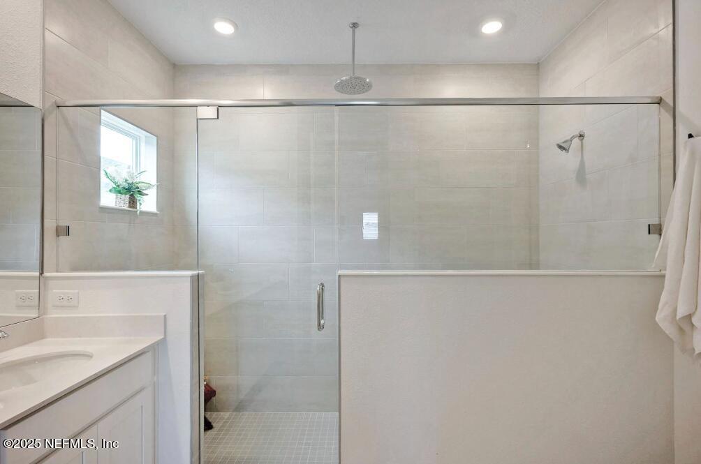 75705 Walking Path Lane Yulee, FL 32097 - Photo 32 of 37 a bathroom with a granite countertop shower and a sink
