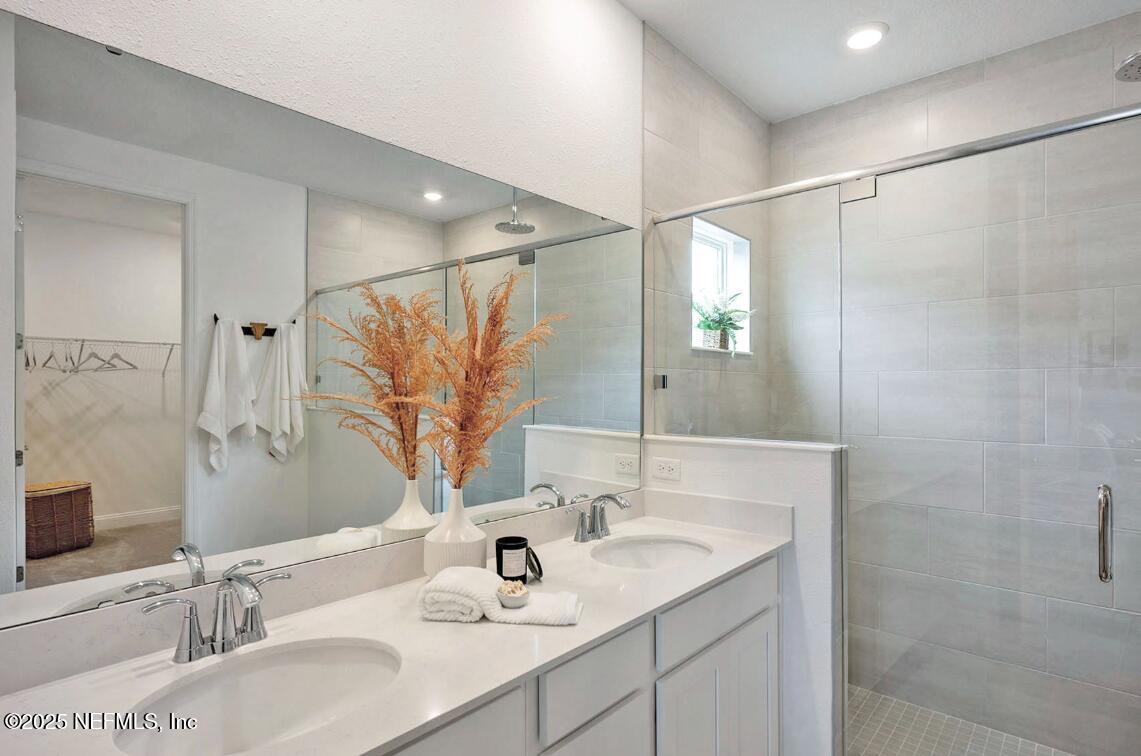 75705 Walking Path Lane Yulee, FL 32097 - Photo 33 of 37 a bathroom with a sink and a mirror