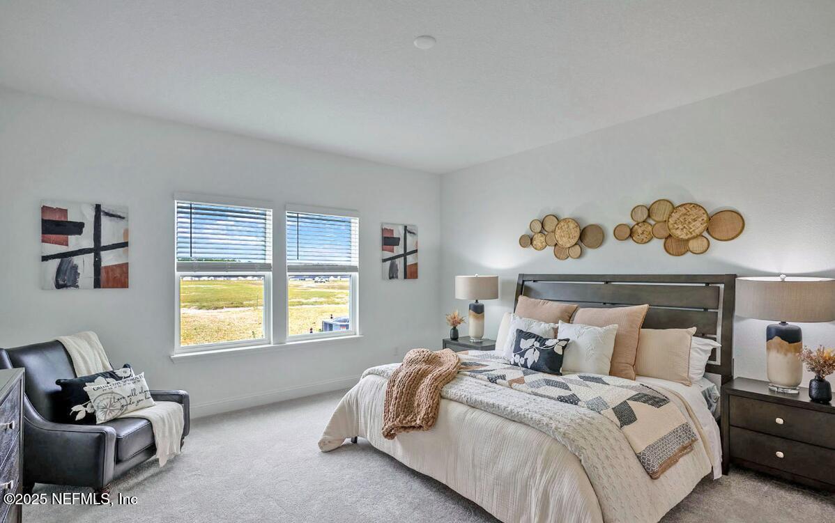 75705 Walking Path Lane Yulee, FL 32097 - Photo 34 of 37 a bed room with a bed and a window