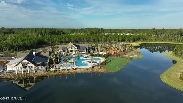 an aerial view of a house with outdoor space lake view and mountain view