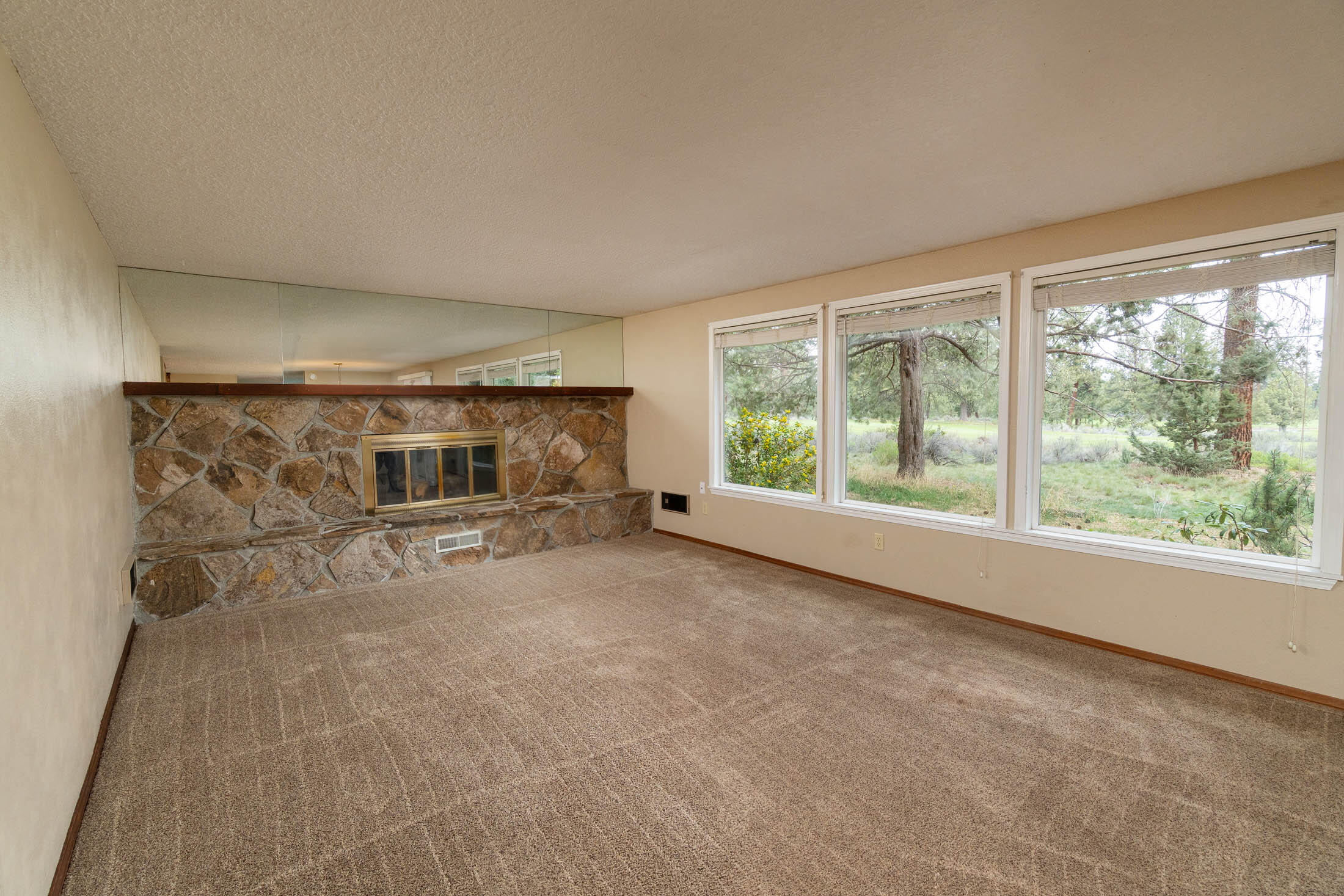 20316 Donkey Sled Road Bend, OR 97702 - Photo 8 of 50 a view of a livingroom with furniture and a fireplace