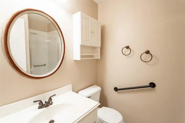 a bathroom with a sink mirror and toilet